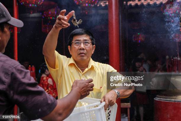 Indonesian ethnic Chinese releases birds, which is believed to bring good luck as a part of Chinese Lunar New Year celebrations at Petak Sembilan...