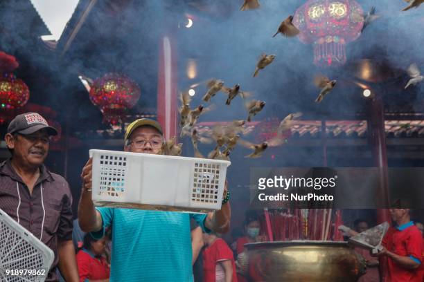 Indonesian ethnic Chinese releases birds, which is believed to bring good luck as a part of Chinese Lunar New Year celebrations at Petak Sembilan...