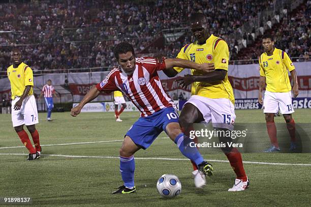 Salvador Cabanas of Paraguay vies for the ball with Cristian Zapata of Colombia during their match as part of the 2010 FIFA World Cup Qualifier at...