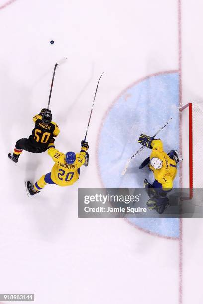 Patrick Hager of Germany controls the puck against Joel Lundqvist of Sweden during the Men's Ice Hockey Preliminary Round Group C game at Kwandong...