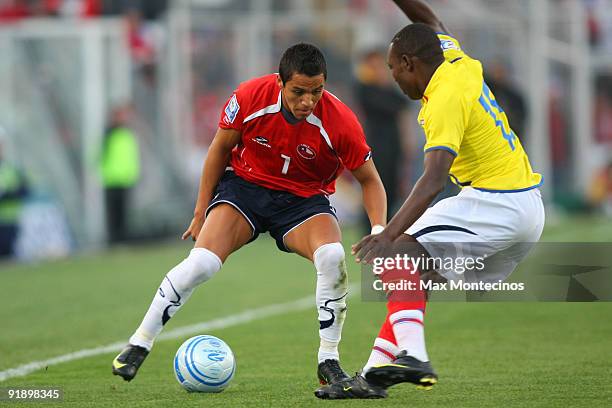 Chile's Alexis Sanchez vies for the ball with Walter Ayovi of Ecuador during their 2010 FIFA World Cup South American qualifier at the Nacional...