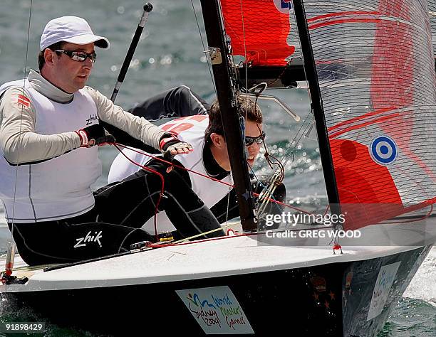 Denmark's Crown Prince Frederik and his crewman Chris Meeham looks under the boom shortly after it had knocked his cap off in the 35 + Tasars sailing...