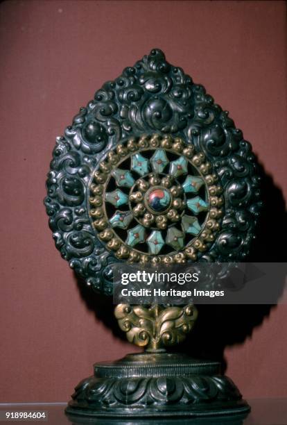 Tibetan Wheel of the Law inlaid with turquoise and coral. The dharmachakra has represented the Buddhist dharma, Gautama Buddha's teaching of the path...