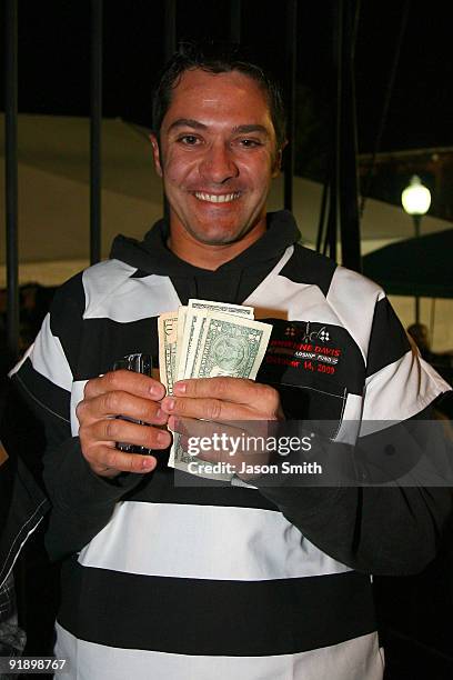 Driver David Stremme shows money raised after he was locked up for charity at the NASCAR Second Annual Jail & Bail held at Brickhouse Tavern October...