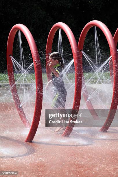 at the splashpad - splash_pad stock pictures, royalty-free photos & images