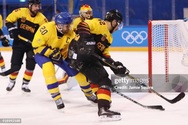 Yasin Ehliz of Germany skates against Joel Lundqvist of Sweden during the Men's Ice Hockey Preliminary Round Group C game at Kwandong Hockey Centre...