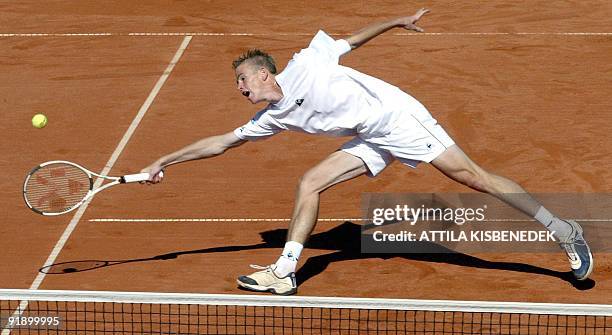 Belgium's Kristof Vliegen stretches for the ball during the Davis cup pair match against Austria, 20 September 2003 in the Werzer Arena on the second...