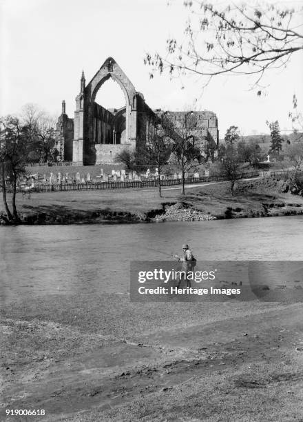 Fisherman on the River Wharfe in front of the ruins of Bolton Priory, North Yorkshire, 1940.