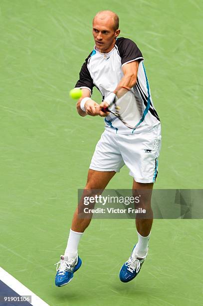 Nikolay Davydenko of Russia returns a shot to Fernando Gonzalez of Chile during day five of 2009 Shanghai ATP Masters 1000 at Qi Zhong Tennis Centre...