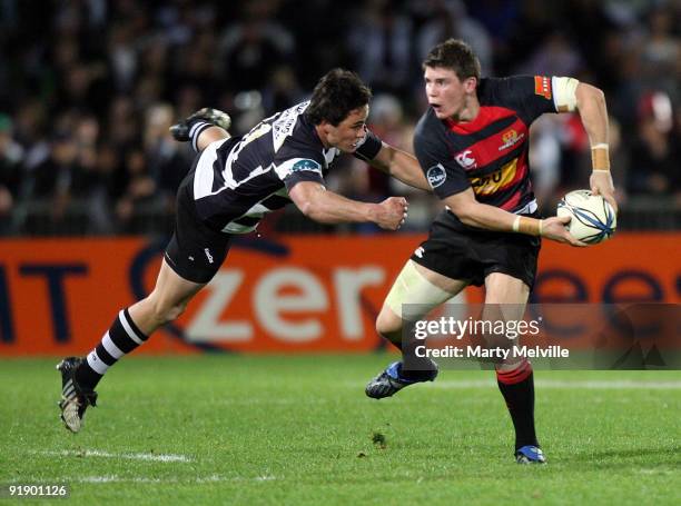 Colin Slade of Canterbury gets tackled by Zac Guildford of Hawks Bay during the Air New Zealand Cup match between the Hawkes Bay Magpies and...