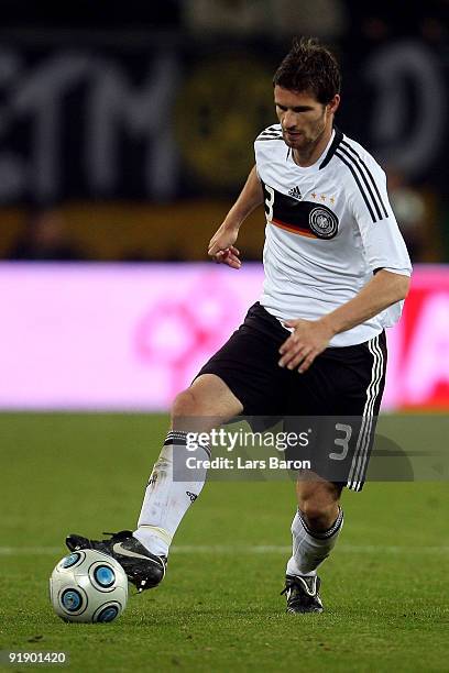 Arne Friedrich of Germany runs with the ball during the FIFA 2010 World Cup Group 4 Qualifier match between Germany and Finland at the HSH Nordbank...