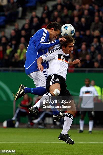 Jonatan Johansson of Finland goes up for a header with Philipp Lahm of Germany during the FIFA 2010 World Cup Group 4 Qualifier match between Germany...