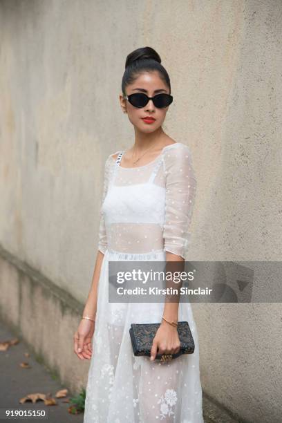 Chinese fashion blogger Carrie Lee wears Dior skirt and top Louis Vuitton bag, Balenciaga shoes and earrings she made herself day 1 of Paris Womens...