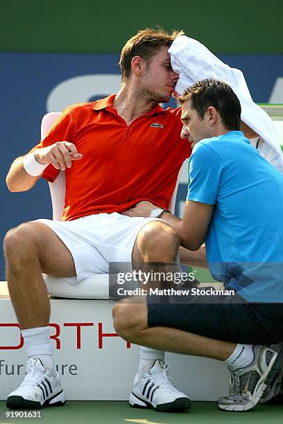 Stanilas Wawrinka of Switzerland receives treatment from trainer Hugo Gravil during day five of the 2009 Shanghai ATP Masters 1000 at Qi Zhong Tennis...