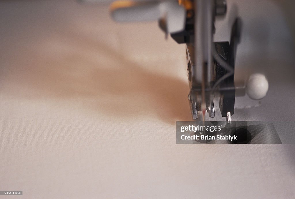 Close-up of Sewing Machine Needle Stitching Cloth