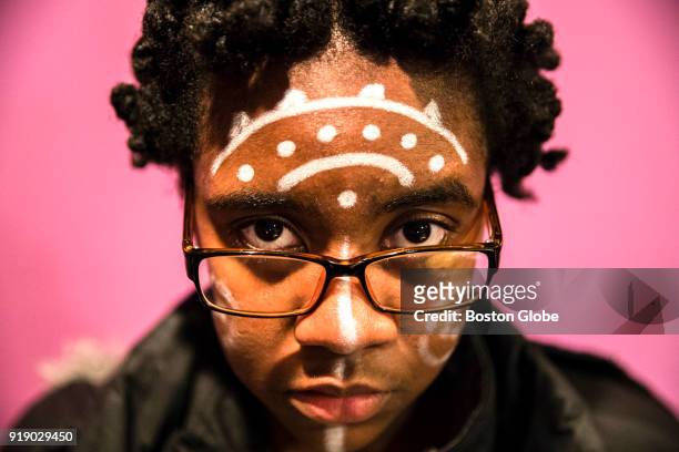 Dainika Balan a student from Boston Arts Academy, wears face paint similar to characters from the "Black Panther" comic book series during a...