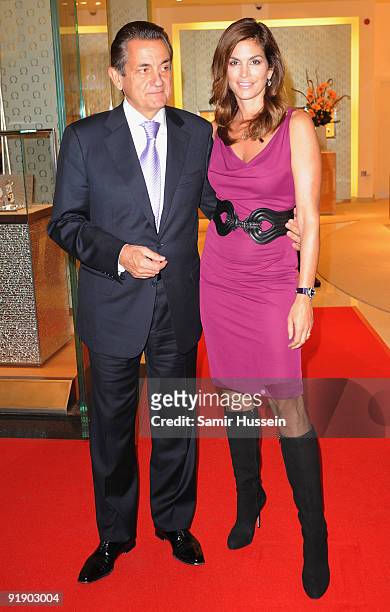 Model and actress Cindy Crawford poses with Omega president Stephen Urquhart as she attends the opening of the Omega Boutique at The Village,...