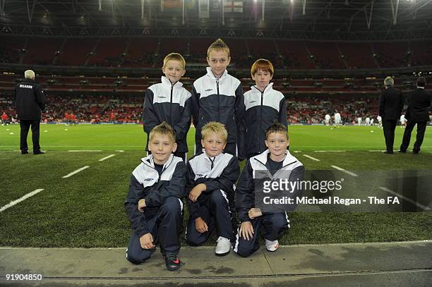 Flag bearers pose during the FIFA 2010 World Cup Group 6 Qualifying match between England and Belarus at Wembley Stadium on October 14, 2009 in...