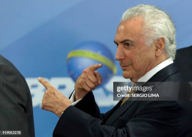 Brazilian President Michel Temer gestures during the signature of a decree to send in the army to lead public safety in Rio de Janeiro, at the...