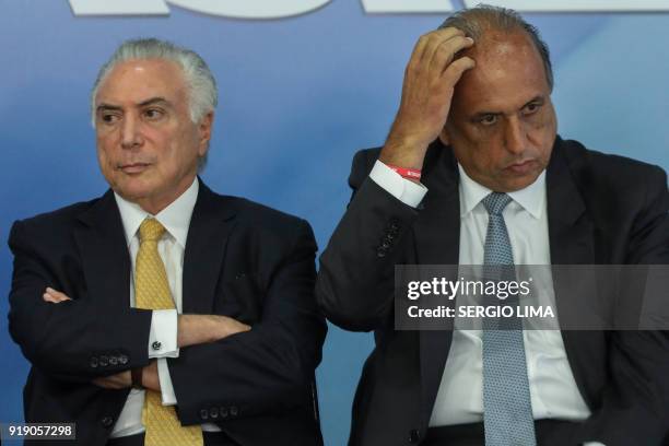 Brazilian President Michel Temer and Rio de Janeiro's Governor Luiz Fernando Pezao, are pictured during the signature of a decree to send in the army...