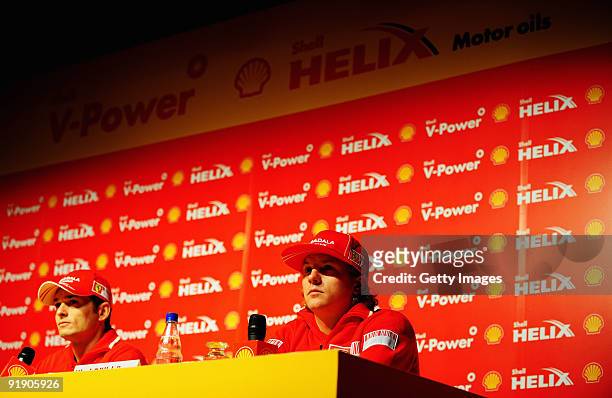 Giancarlo Fisichella of Italy and Ferrari and Kimi Raikkonen of Finland and Ferrari talk at a Shell press conference during previews to the Brazilian...