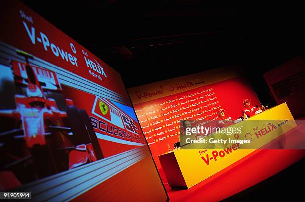 Giancarlo Fisichella of Italy and Ferrari and Kimi Raikkonen of Finland and Ferrari talk at a Shell press conference during previews to the Brazilian...