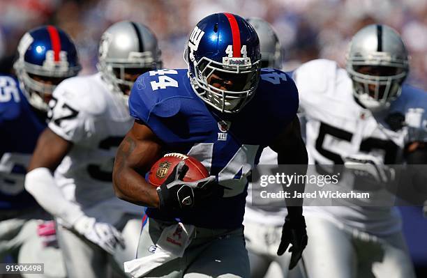 Ahmad Bradshaw of the New York Giants runs past the Oakland Raiders defense for a touchdown in the first quarter during the game on October 11, 2009...