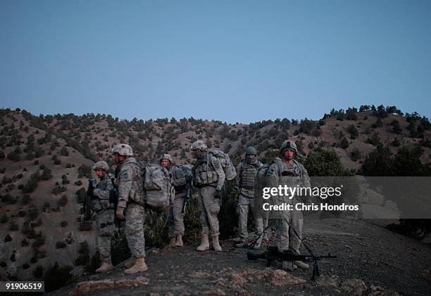 Soldiers in the 1/501st of the 25th Infantry Division prepare to leave a mountain where they spent the night in a Taliban stronghold area October 15,...