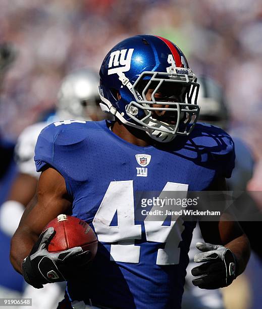 Ahmad Bradshaw of the New York Giants runs past the Oakland Raiders defense for a touchdown in the first quarter during the game on October 11, 2009...