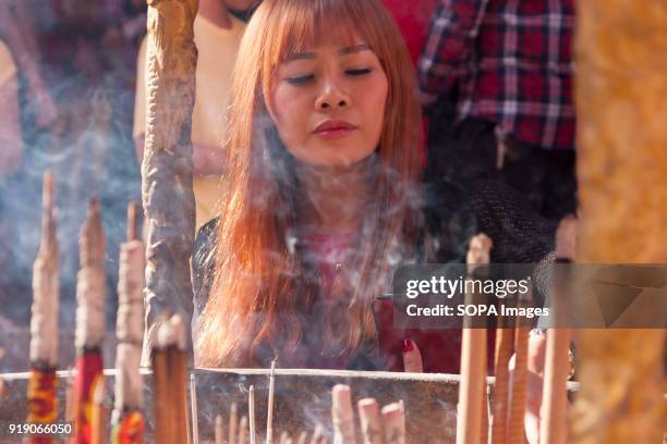 Women seen burning incense stick at the Thean Hou Temple on the first day of Chinese New Year. Chinese New Year is the first day of the New Year in...