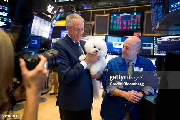 Flynn, the Bichon Frise who won Best in Show at the 142nd Westminster Kennel Club Dog Show, and his handler Bill McFadden, left, stand for a...