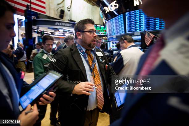 Traders work on the floor of the New York Stock Exchange in New York, U.S., on Friday, Feb. 16, 2018. U.S. Equities headed for the best week in six...
