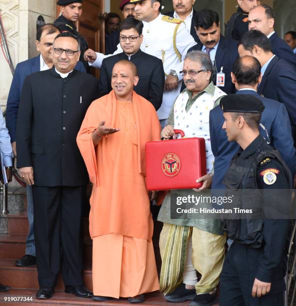 Chief Minister Yogi Adityanath along with Finance Minister of UP government Rajesh Agarwal show a red briefcase to present the state Budget for...