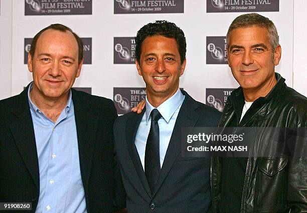 Actors George Clooney Kevin Spacey and director Grant Heslov pose for pictures during a photocall in London's Leicester Square for the British...