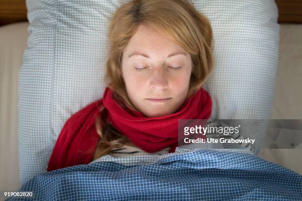 Bonn, Germany Posed Scene: A sick woman lies in bed and sleeps on February 13, 2018 in Bonn, Germany.
