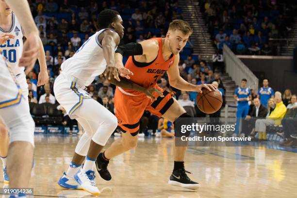 Oregon State Beavers forward Tres Tinkle drives the ball around UCLA Bruins guard Kris Wilkes during the game between the Oregon State Beavers and...