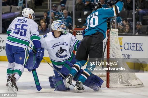 Vancouver Canucks goaltender Anders Nilsson accidently trips San Jose Sharks left wing Marcus Sorensen during the first period of the regular season...