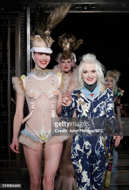 Designer Pam Hogg and a model walk the runway at the Pam Hogg show during London Fashion Week February 2018 at The Freemason's Hall on February 16,...