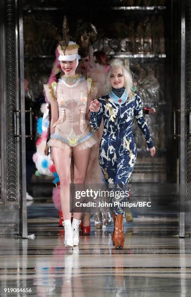 Designer Pam Hogg and a model walk the runway at the Pam Hogg show during London Fashion Week February 2018 at The Freemason's Hall on February 16,...