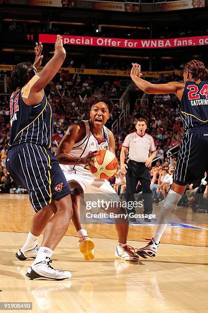 Cappie Pondexter of the Phoenix Mercury makes a move to the basket against Ebony Hoffman and Tamika Catchings of the Indiana Fever in Game Five of...