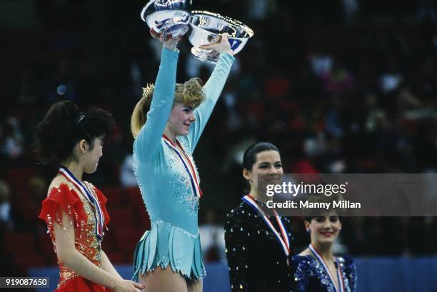 Nationals: Closeup of Kristi Yamaguchi, Tonya Harding, and Nancy Kerrigan victorious on medal stand with flowers after event at Target Center....