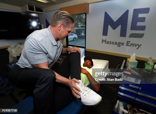 Tony Finau receives a treatment by Massage Envy Physical Therapist Jeff Hendra during the Genesis Open at Riviera Country Club on February 14, 2018...