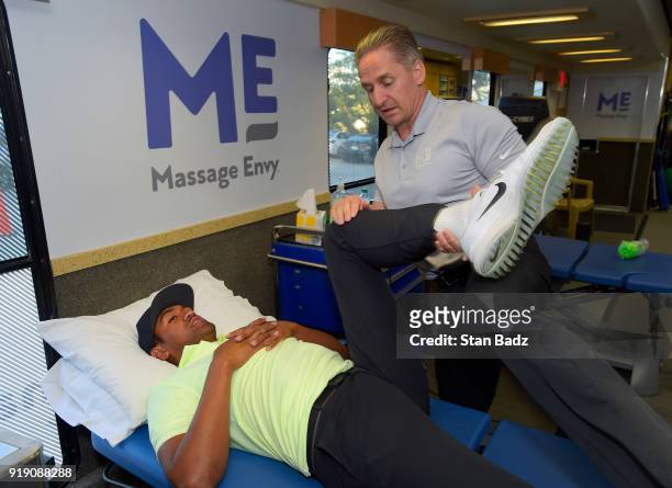 Tony Finau receives a treatment by Massage Envy Physical Therapist Jeff Hendra during the Genesis Open at Riviera Country Club on February 14, 2018...