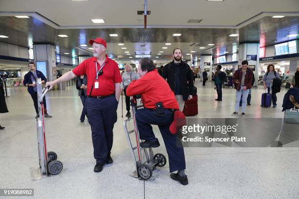 Train porters rest at New York's Pennsylvania Station on February 16, 2018 in New York City. Amtrak gave a media tour on Friday to show the progress...