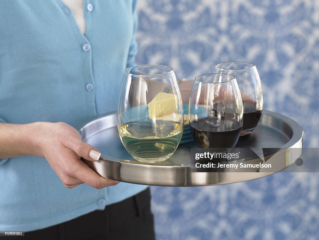 Chrome tray with white and red wine in stemless glasses