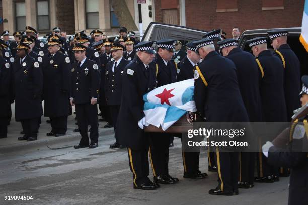 Draped with a city of Chicago plag, the remains of Police Commander Paul Bauer arrive at the Nativity of Our Lord church in the Bridgeport...