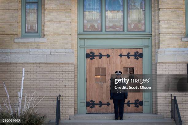 Chicago police officer stands guard outside of the Nativity of Our Lord church in the Bridgeport neighborhood after the remains of Commander Paul...