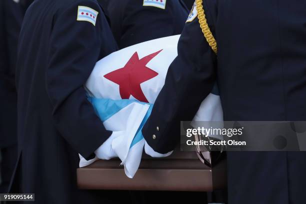 Draped with a city of Chicago plag, the remains of Police Commander Paul Bauer arrive at the Nativity of Our Lord church in the Bridgeport...