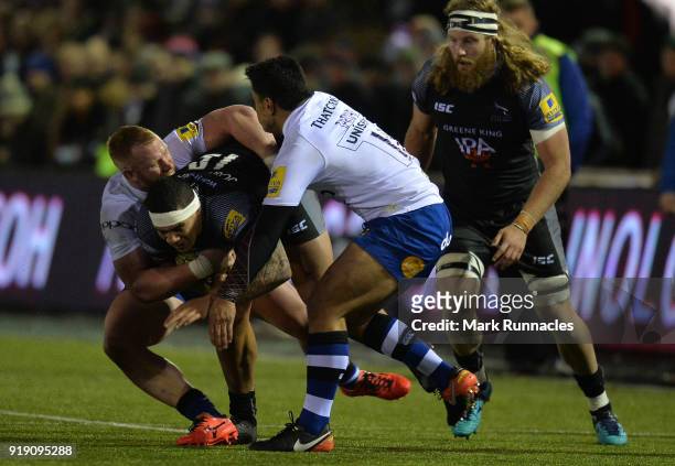 Josh Matavesi of Newcastle Falcons tackled by Ben Tapuai and Will Hurrell of Bath Rugby during the Aviva Premiership match between Newcastle Falcons...