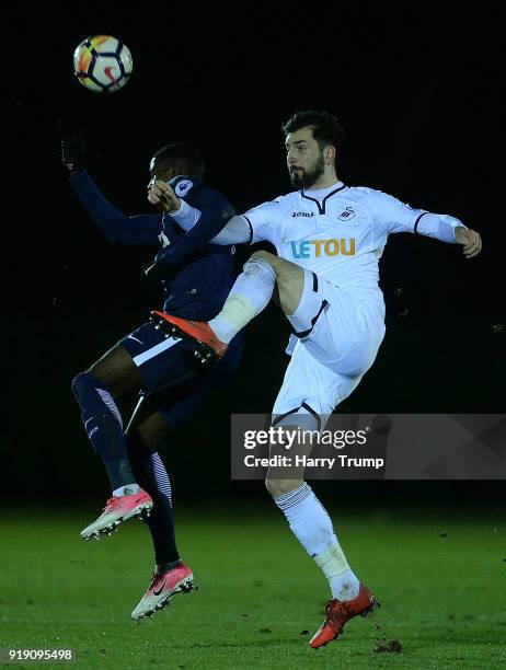 Matic Pajik of Swansea City challenges for the ball with Shilow Tracey of Tottenham Hotspur during the Premier League 2 match between Swansea City...